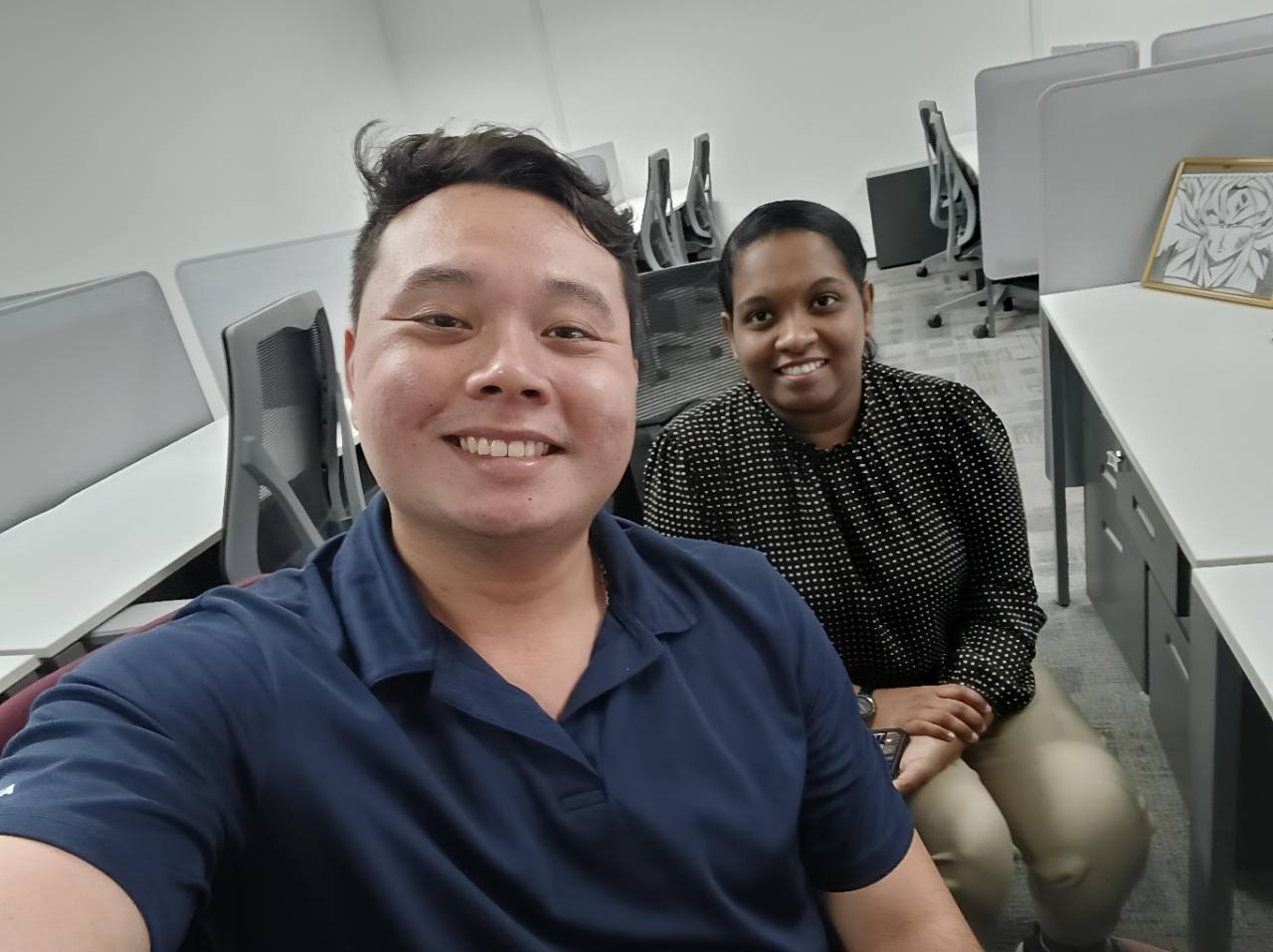Alvin smiling with a client during an in-person office meeting.